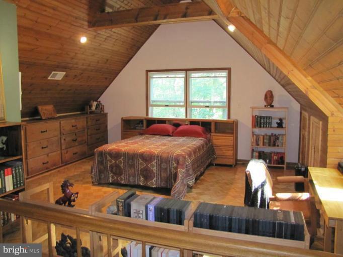 Mstr Bdrm has built-in dressers and wood flooring.