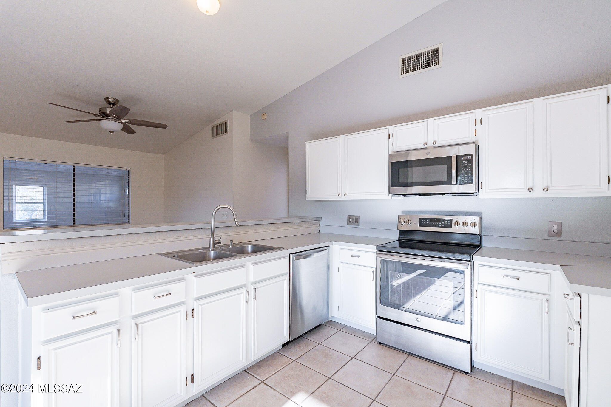 2690 West Sunset Road Tucson, AZ 85741 - Photo 5 of 33 a kitchen with a sink stove and microwave