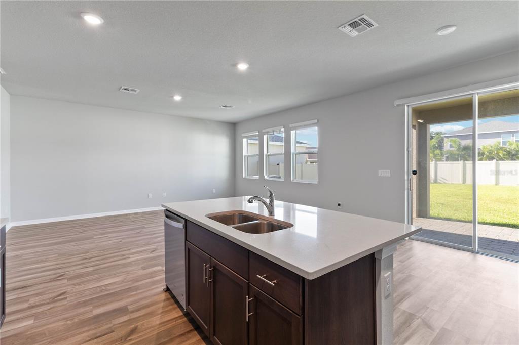 5617 Bungalow Grove Court Palmetto, FL 34221 - Photo 13 of 31 a kitchen with a sink cabinets and wooden floor