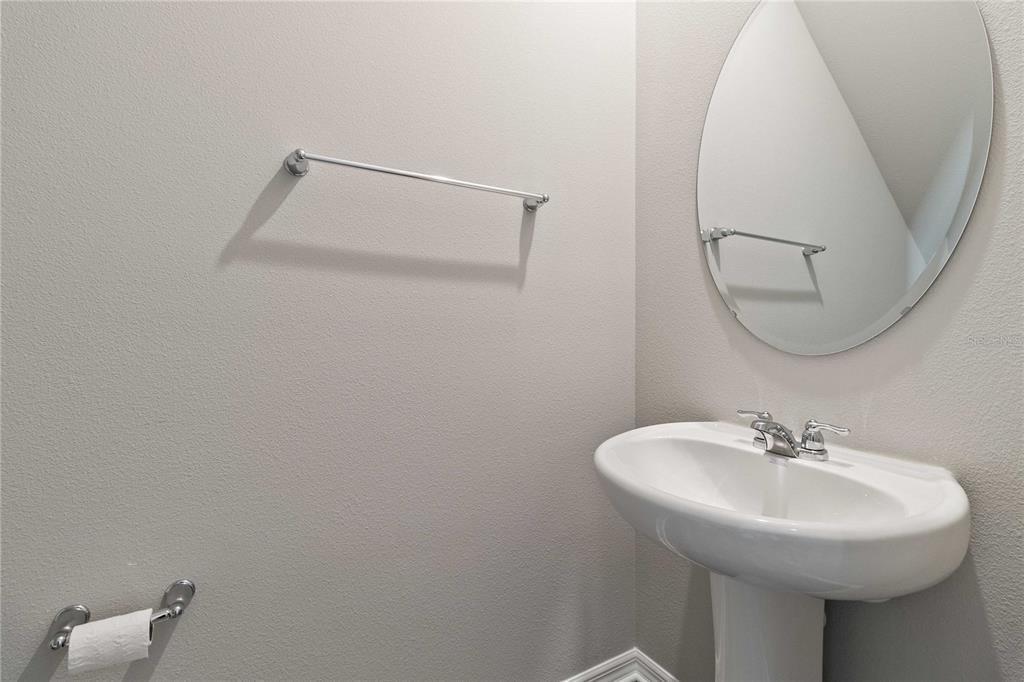 5617 Bungalow Grove Court Palmetto, FL 34221 - Photo 15 of 31 a bathroom with a sink a mirror and a shower