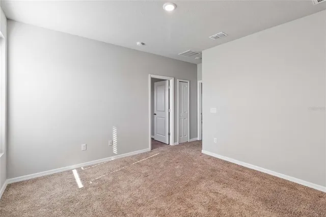 a view of an empty room and closet area