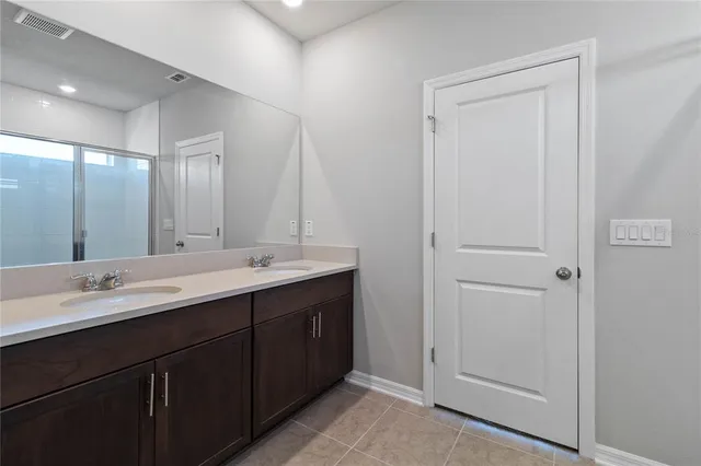 a bathroom with a glass shower door