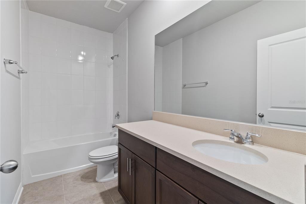 5617 Bungalow Grove Court Palmetto, FL 34221 - Photo 26 of 31 a bathroom with a sink a toilet and shower