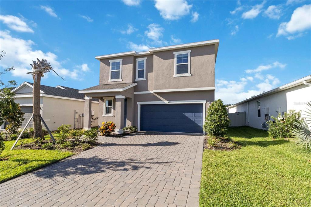 5617 Bungalow Grove Court Palmetto, FL 34221 - Photo 4 of 31 a front view of a house with garden