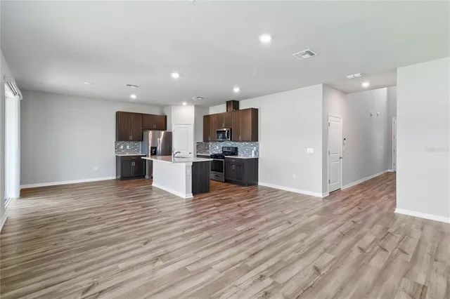 a kitchen with kitchen island a sink stainless steel appliances and cabinets