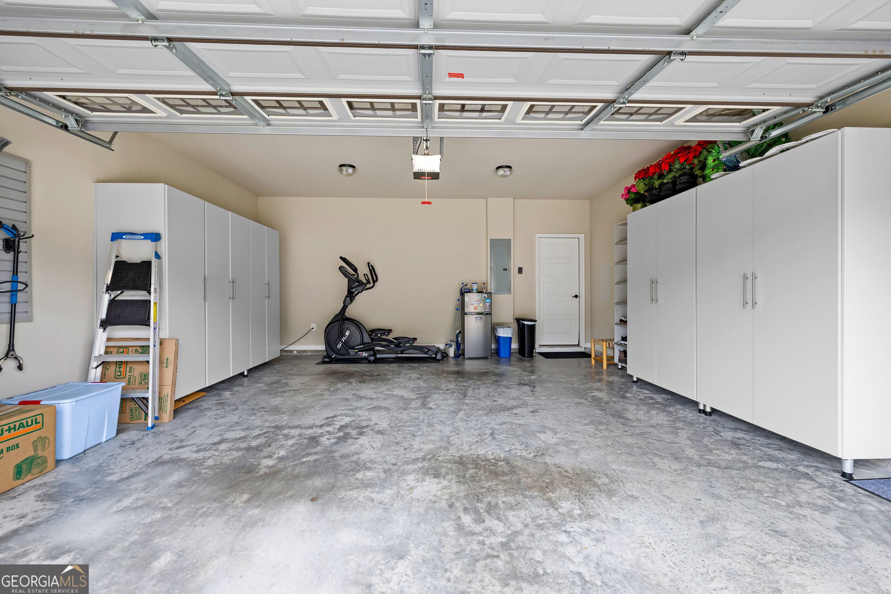 12 Delaware Way Newnan, GA 30265 - Photo 55 of 61 Two-car garage with built-in storage cabinetry and sealed concrete flooring.