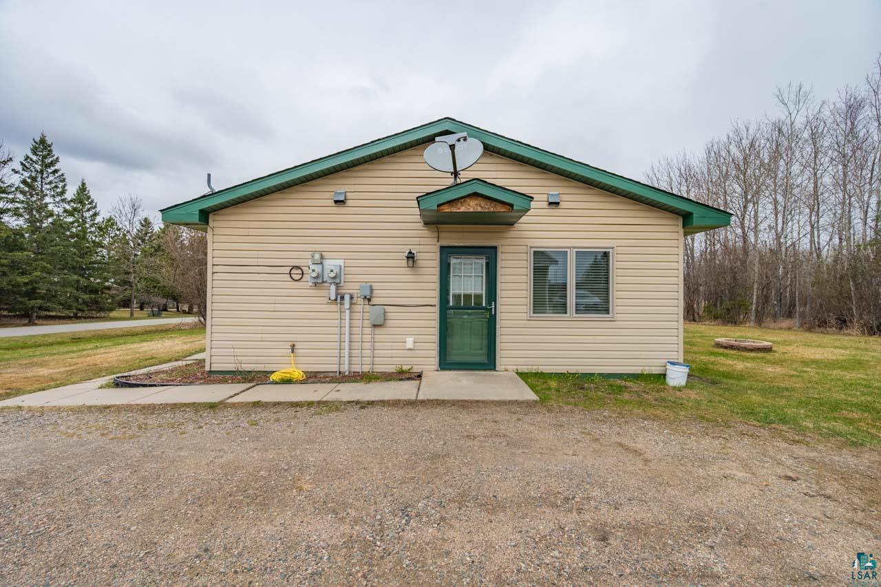 228 3rd Street Southeast Cook, MN 55723 - Photo 20 of 30 Single-story structure featuring beige siding and a dark green gable roof