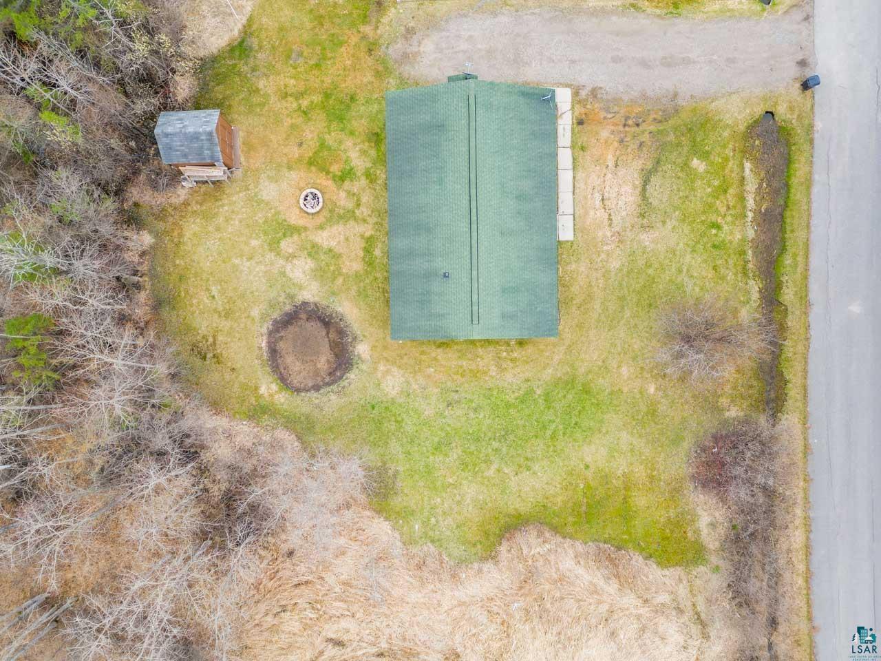 228 3rd Street Southeast Cook, MN 55723 - Photo 21 of 30 Property featuring a green roof structure, gravel driveway, and a roadside location
