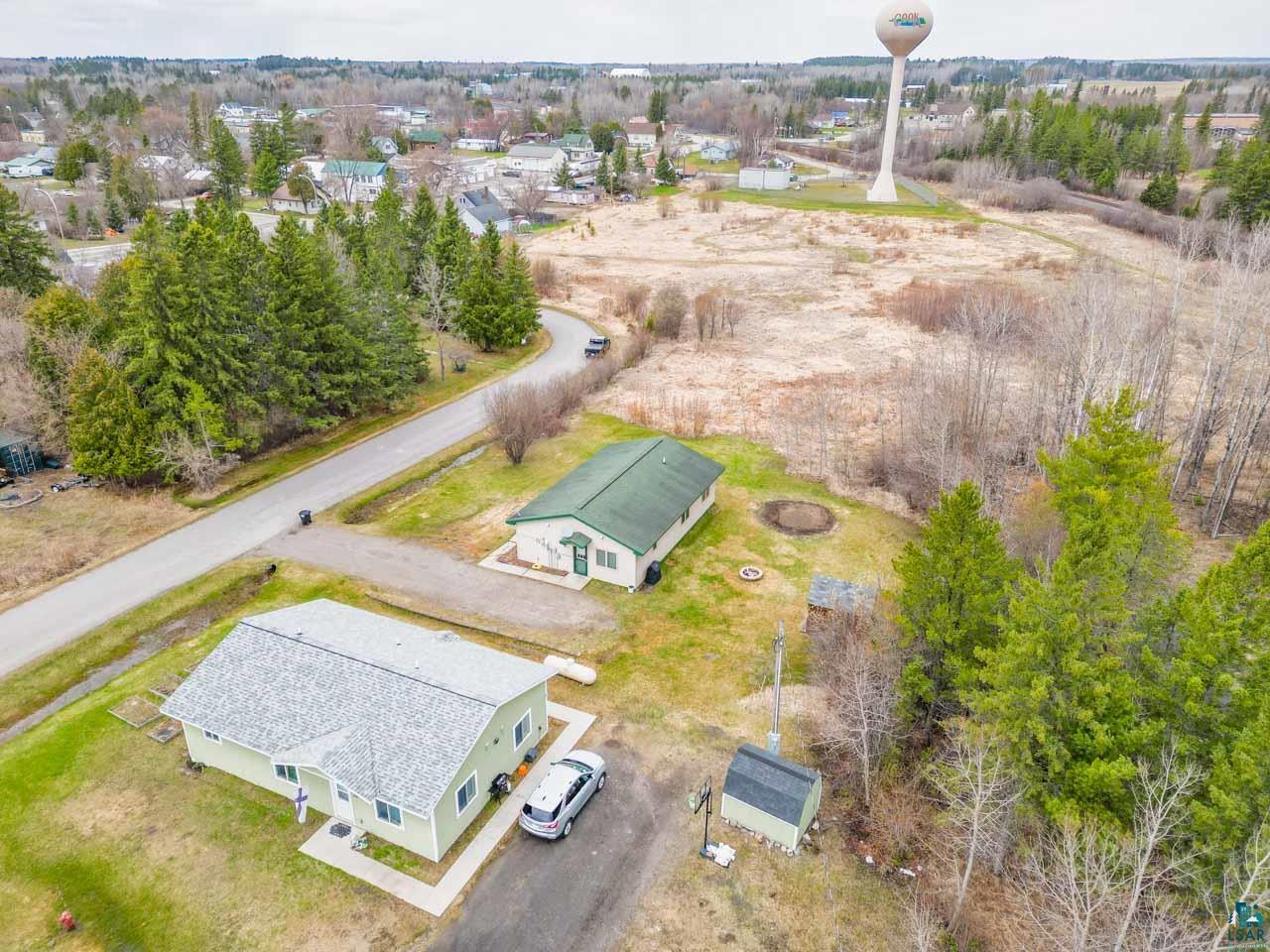 228 3rd Street Southeast Cook, MN 55723 - Photo 27 of 30 Aerial perspective showcasing the property with a light green exterior and a shingled roof
