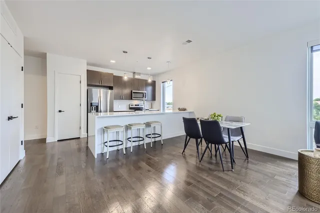 a view of a dining room with furniture and wooden floor