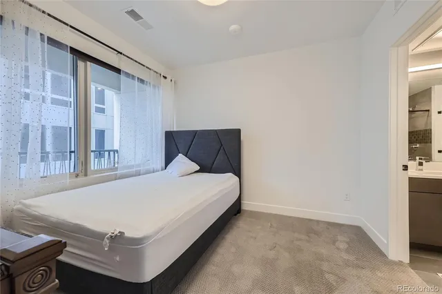 a bed sitting in a room next to a window