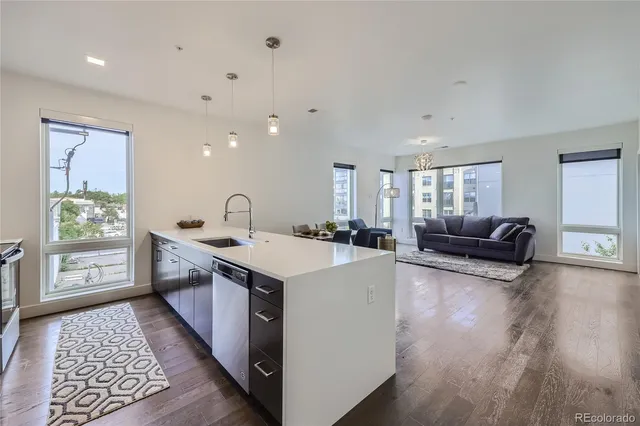 a view of living room with furniture and wooden floor