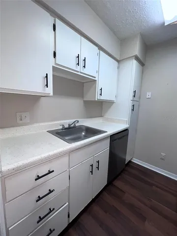 a kitchen with appliances cabinets and a sink