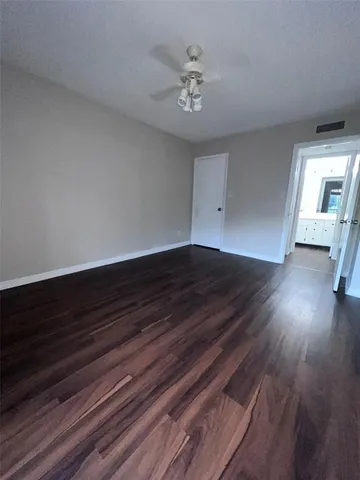 a view of an empty room and wooden floor