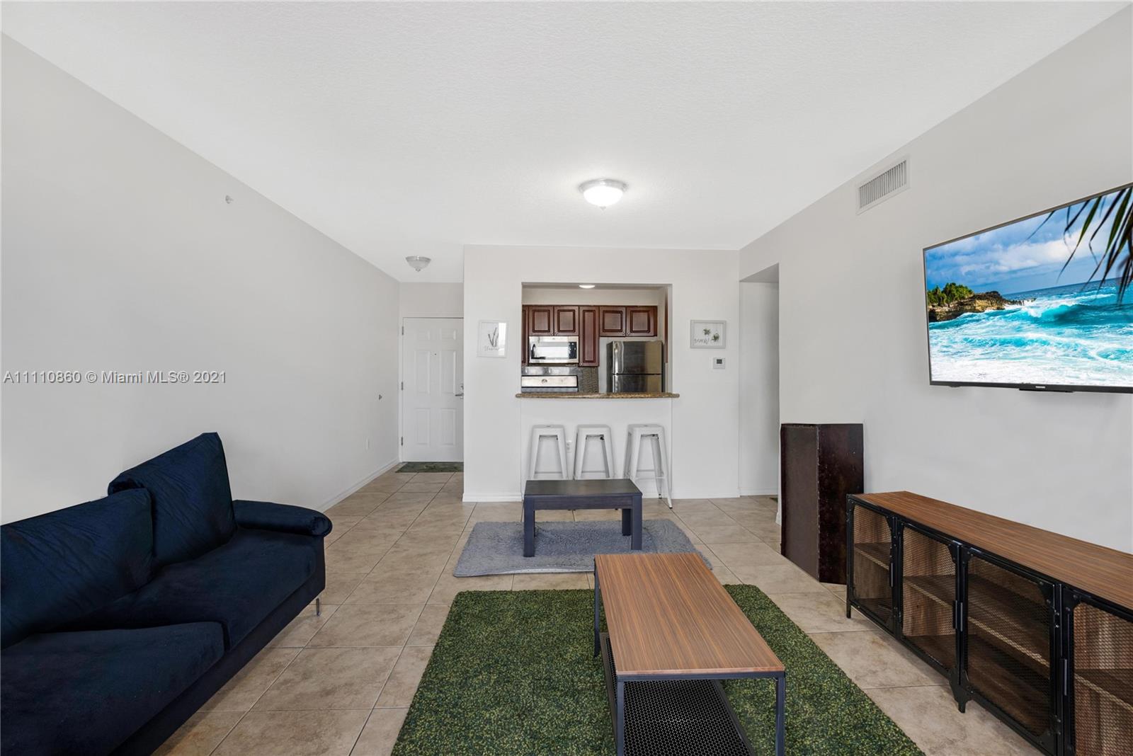 900 Southwest 8th Street, Unit 904 Miami, FL 33130 - Photo 2 of 12 a living room with furniture and a wooden floor