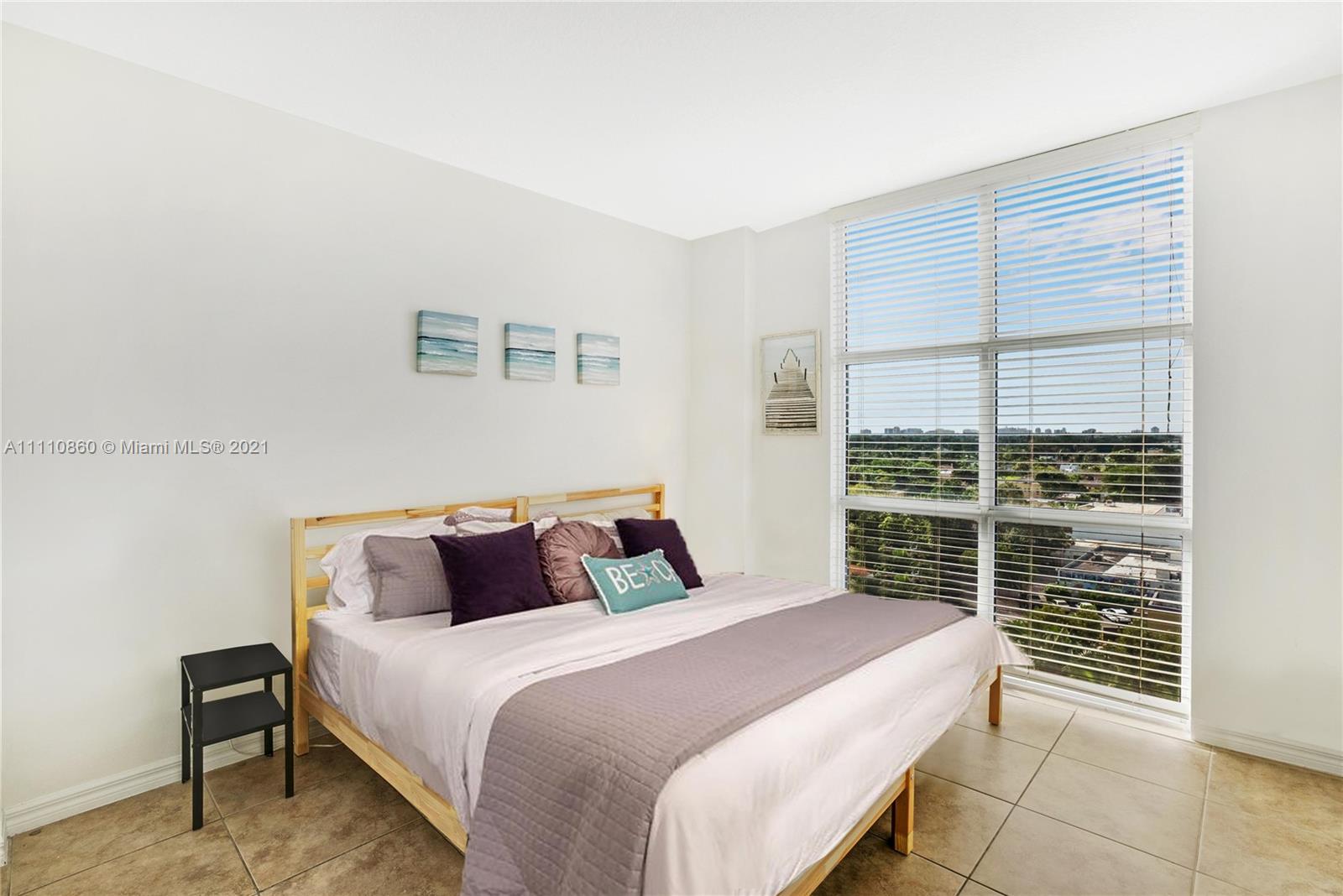 900 Southwest 8th Street, Unit 904 Miami, FL 33130 - Photo 3 of 12 a bedroom with a bed and a window