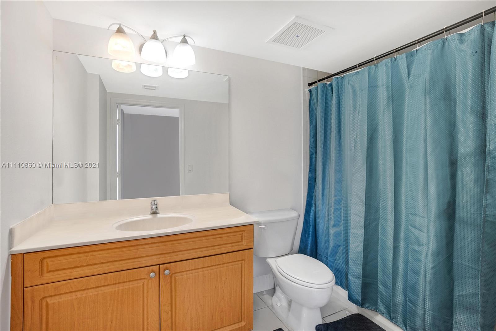900 Southwest 8th Street, Unit 904 Miami, FL 33130 - Photo 5 of 12 a bathroom with a toilet sink and mirror