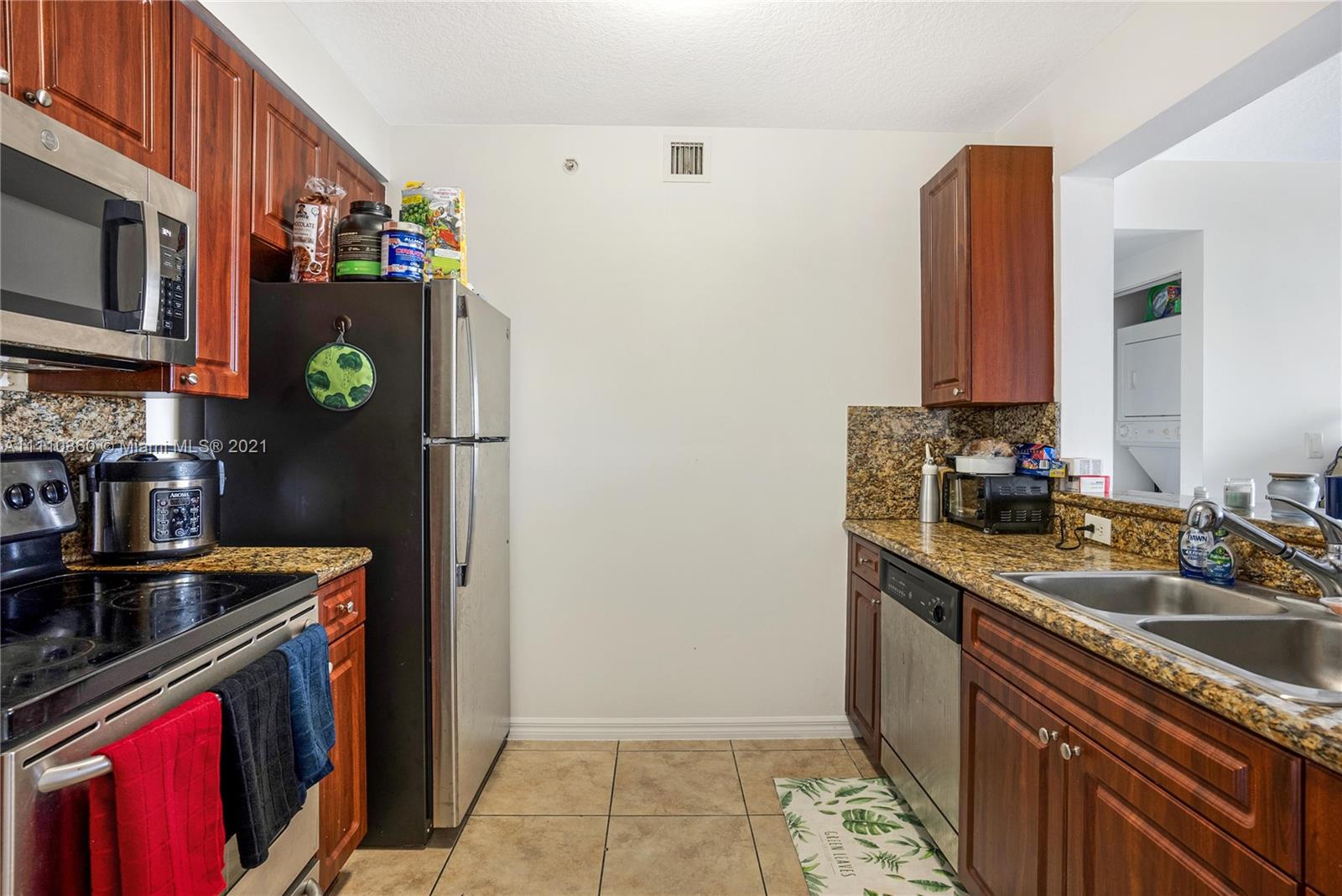 900 Southwest 8th Street, Unit 904 Miami, FL 33130 - Photo 6 of 12 a kitchen with stainless steel appliances granite countertop a refrigerator and a stove