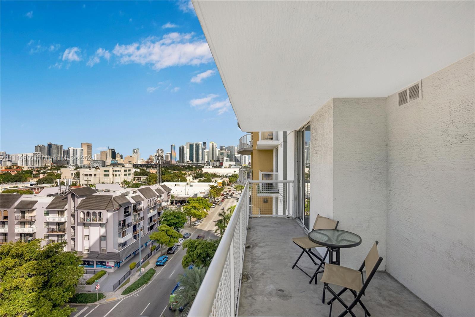 900 Southwest 8th Street, Unit 904 Miami, FL 33130 - Photo 9 of 12 a view of a balcony with furniture and a kitchen