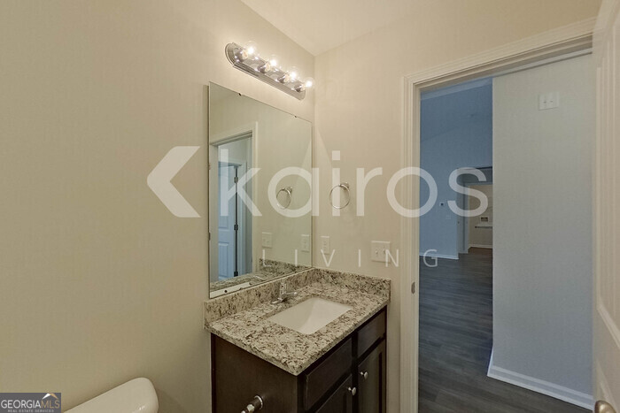 108 St Phillip Way Springfield, GA 31329 - Photo 17 of 29 a bathroom with a granite countertop sink a toilet and a mirror