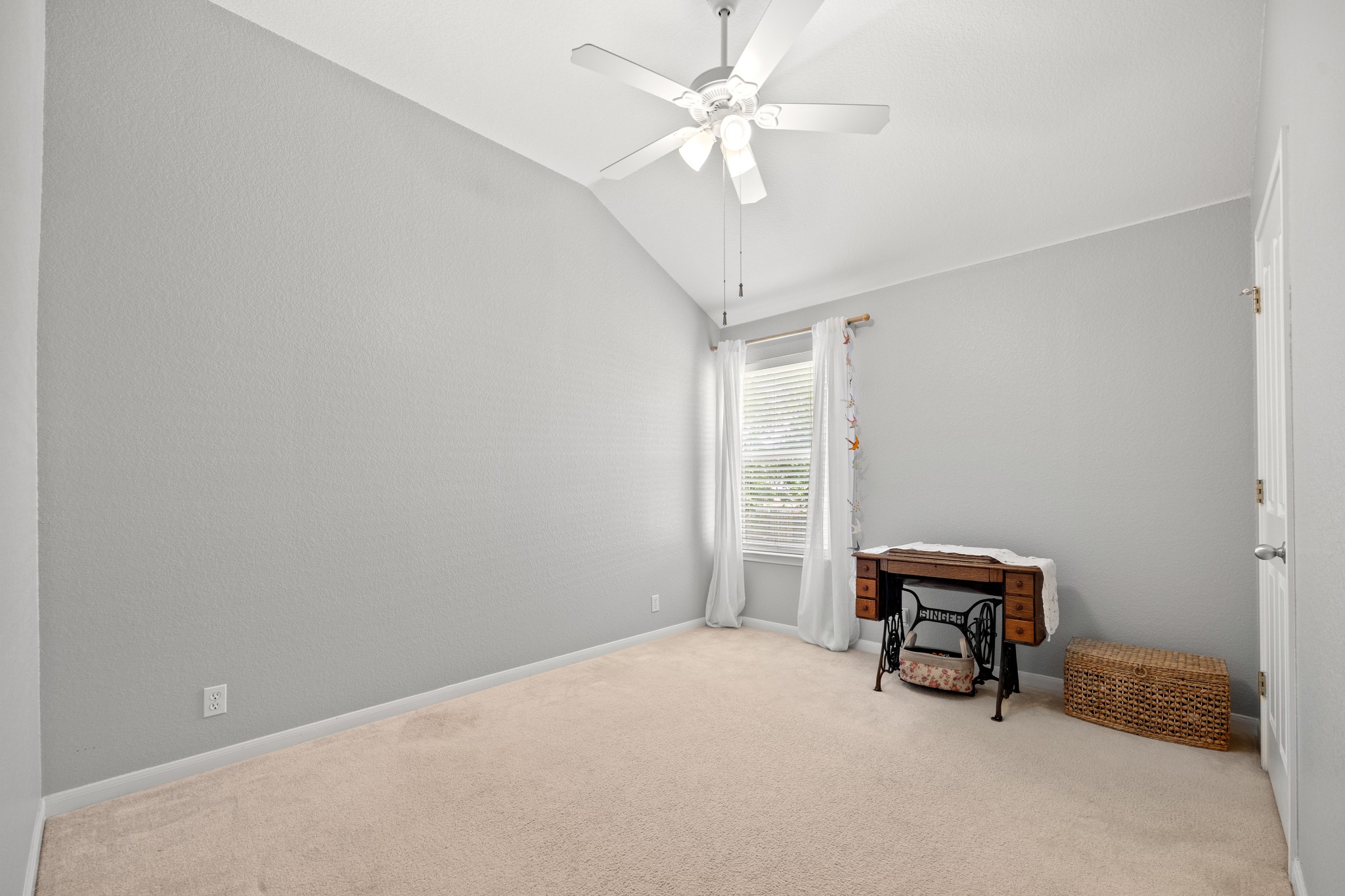 1108 Springbrook Road Pflugerville, TX 78660 - Photo 25 of 37 A spacious room features soaring vaulted ceilings and plush carpet, ideal for relaxation.