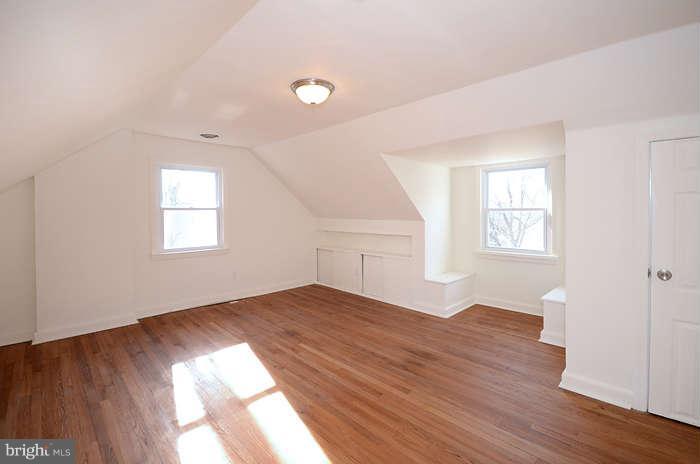 4305 Wakefield Road Baltimore, MD 21216 - Photo 11 of 25 an empty room with wooden floor and windows