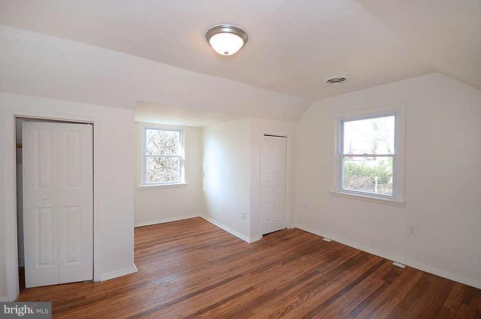 4305 Wakefield Road Baltimore, MD 21216 - Photo 13 of 25 a view of an empty room with wooden floor and a window