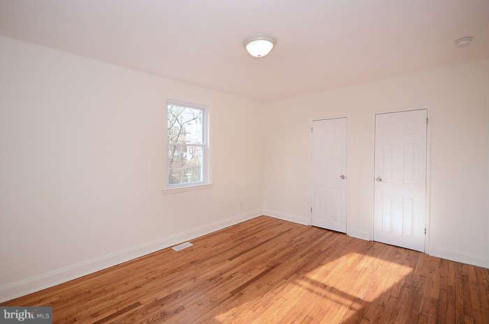 4305 Wakefield Road Baltimore, MD 21216 - Photo 14 of 25 a view of empty room with wooden floor and fan