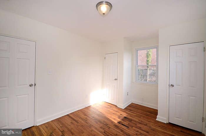 4305 Wakefield Road Baltimore, MD 21216 - Photo 16 of 25 a view of an empty room with wooden floor and closet