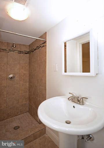 4305 Wakefield Road Baltimore, MD 21216 - Photo 18 of 25 a bathroom with a sink a toilet and shower