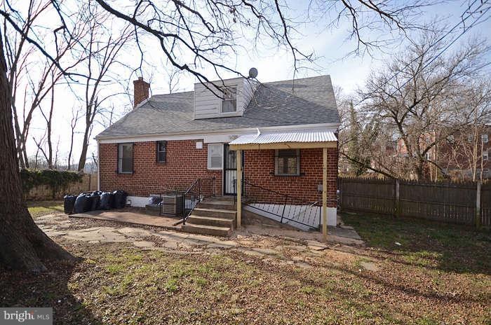 4305 Wakefield Road Baltimore, MD 21216 - Photo 6 of 25 a house that has a tree in front of it