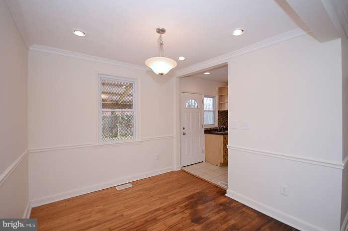 4305 Wakefield Road Baltimore, MD 21216 - Photo 7 of 25 wooden floor in an empty room with a window