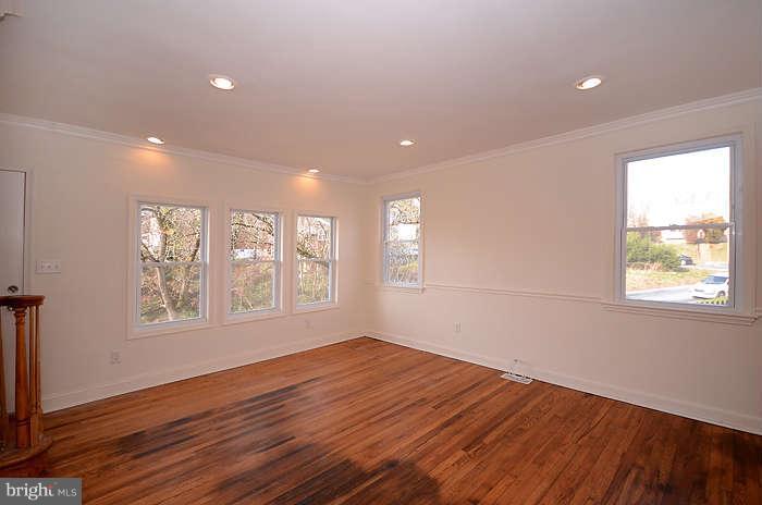 4305 Wakefield Road Baltimore, MD 21216 - Photo 8 of 25 a view of an empty room with wooden floor and a window