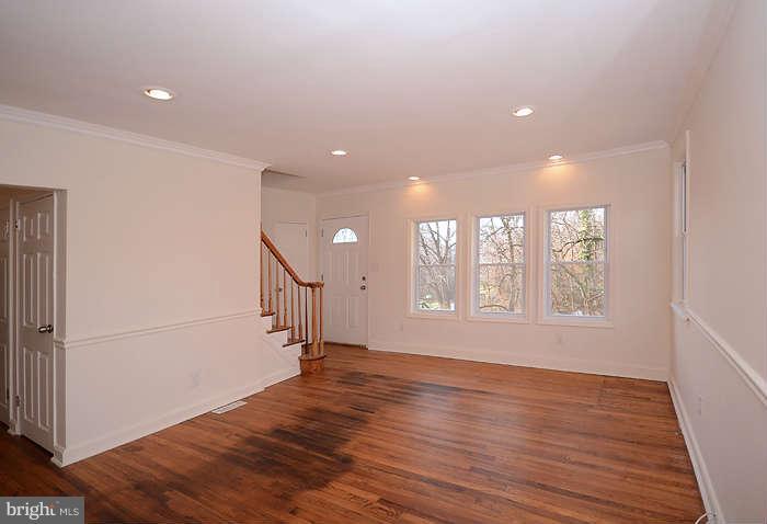 4305 Wakefield Road Baltimore, MD 21216 - Photo 9 of 25 a view of an empty room with wooden floor and a window