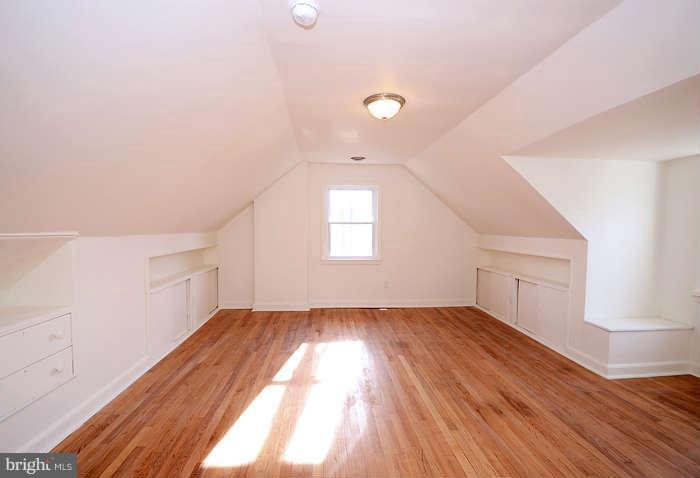 4305 Wakefield Road Baltimore, MD 21216 - Photo 10 of 25 an empty room with wooden floor and windows