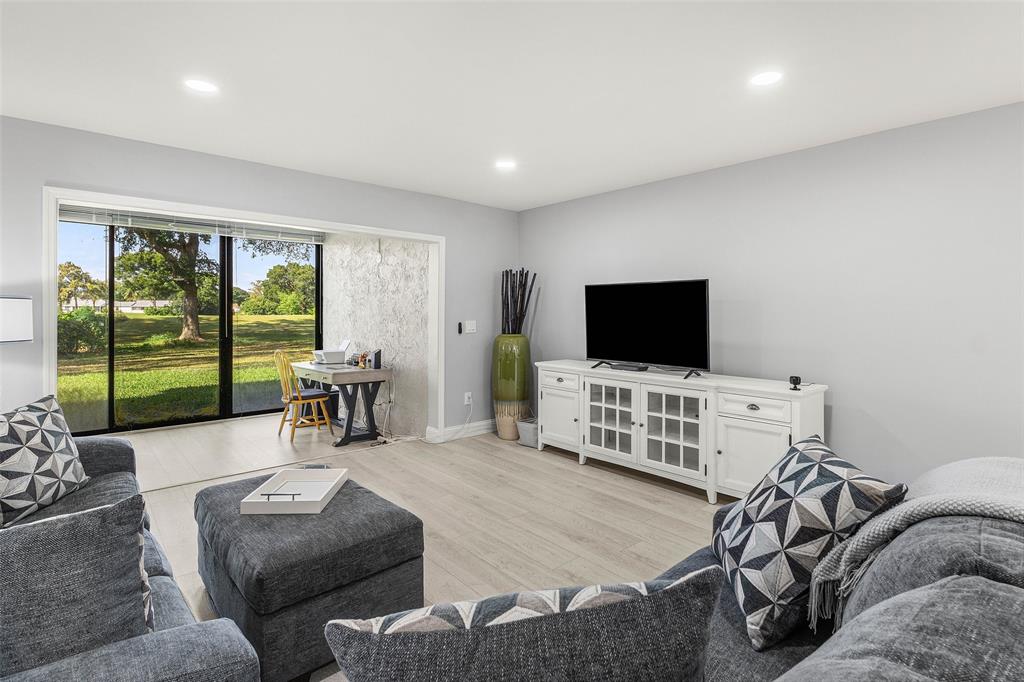 9286 Vista Del Lago, Unit E Boca Raton, FL 33428 - Photo 11 of 26 a living room with furniture and a flat screen tv