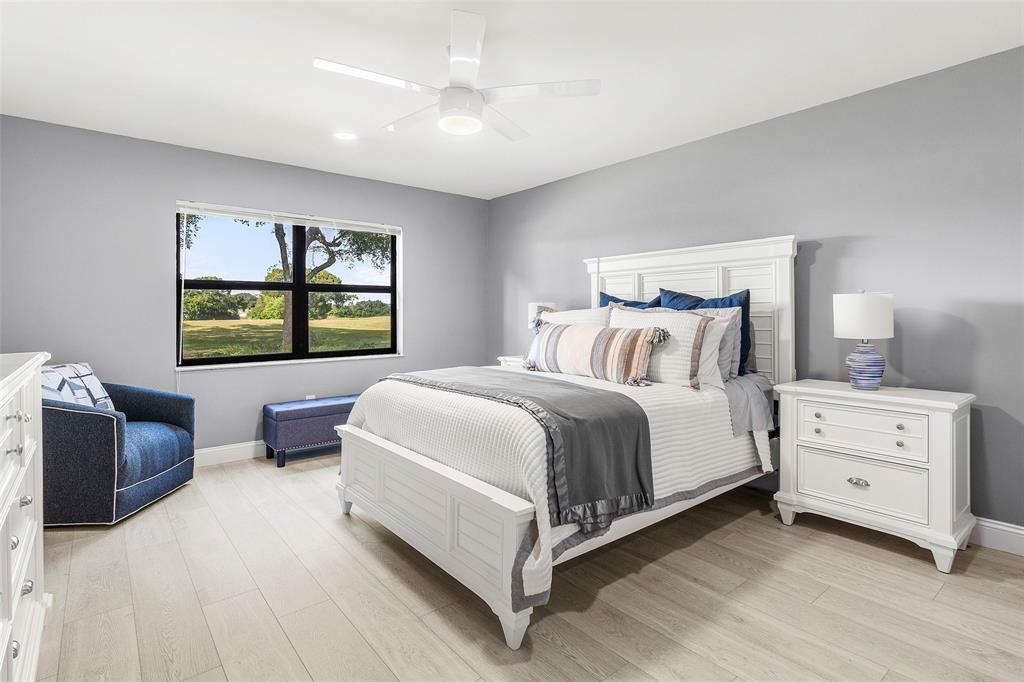 9286 Vista Del Lago, Unit E Boca Raton, FL 33428 - Photo 14 of 26 a bedroom with a bed and a dresser