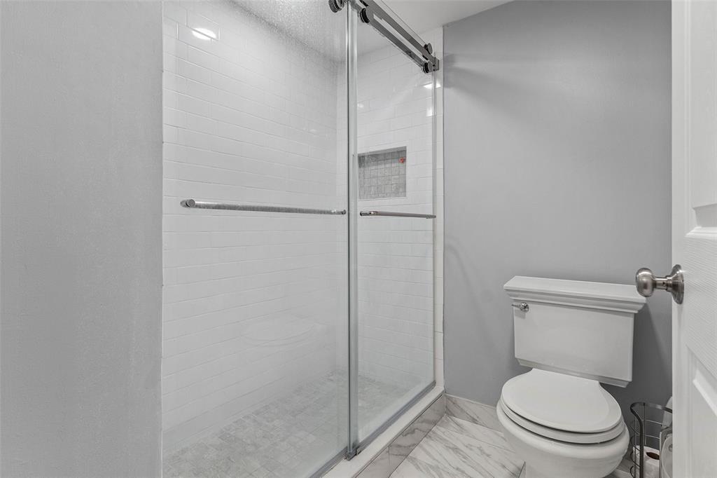 9286 Vista Del Lago, Unit E Boca Raton, FL 33428 - Photo 17 of 26 a bathroom with a toilet and a shower