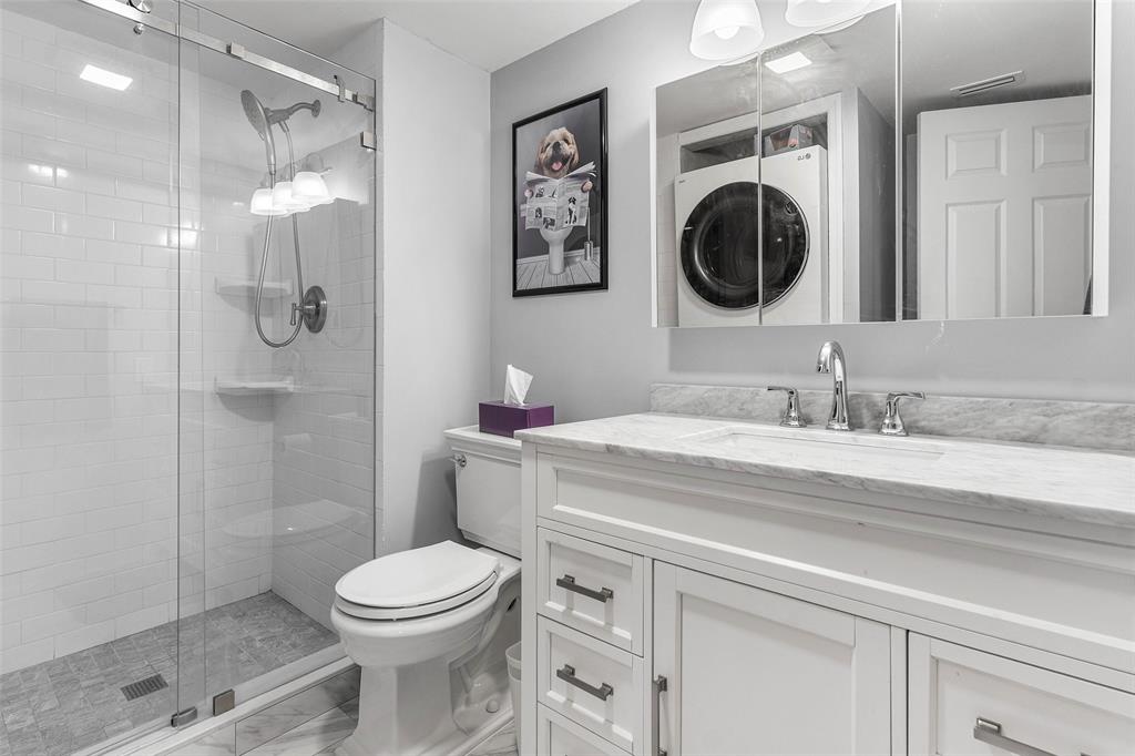 9286 Vista Del Lago, Unit E Boca Raton, FL 33428 - Photo 19 of 26 a bathroom with a toilet a sink and mirror