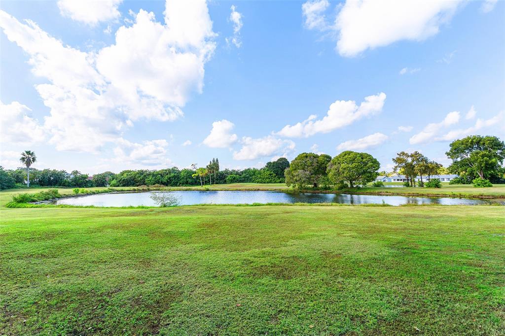 9286 Vista Del Lago, Unit E Boca Raton, FL 33428 - Photo 2 of 26 a view of a lake and houses in the background