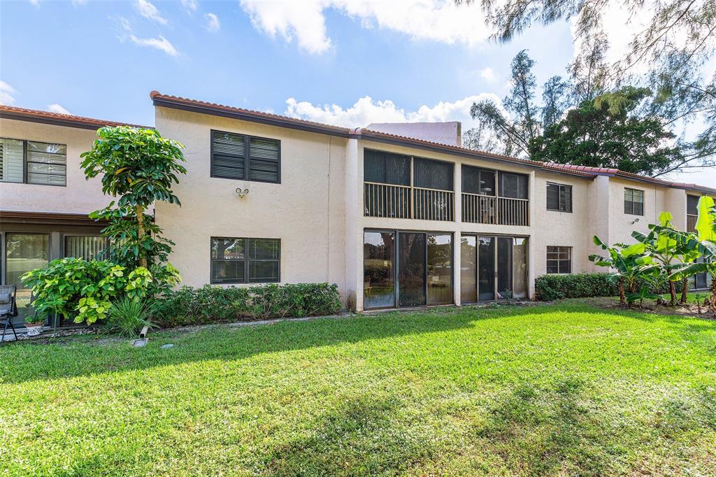 9286 Vista Del Lago, Unit E Boca Raton, FL 33428 - Photo 26 of 26 a view of a house with a yard and plants