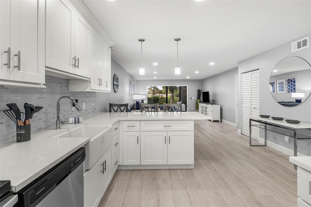 9286 Vista Del Lago, Unit E Boca Raton, FL 33428 - Photo 3 of 26 a kitchen with sink stove and cabinets