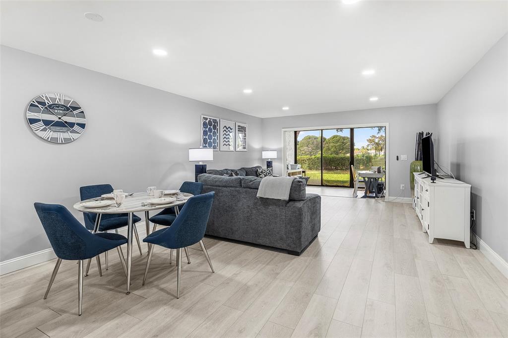 9286 Vista Del Lago, Unit E Boca Raton, FL 33428 - Photo 4 of 26 a living room with furniture and a large window