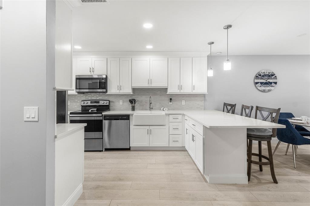 9286 Vista Del Lago, Unit E Boca Raton, FL 33428 - Photo 5 of 26 a kitchen with a sink white cabinets and stainless steel appliances