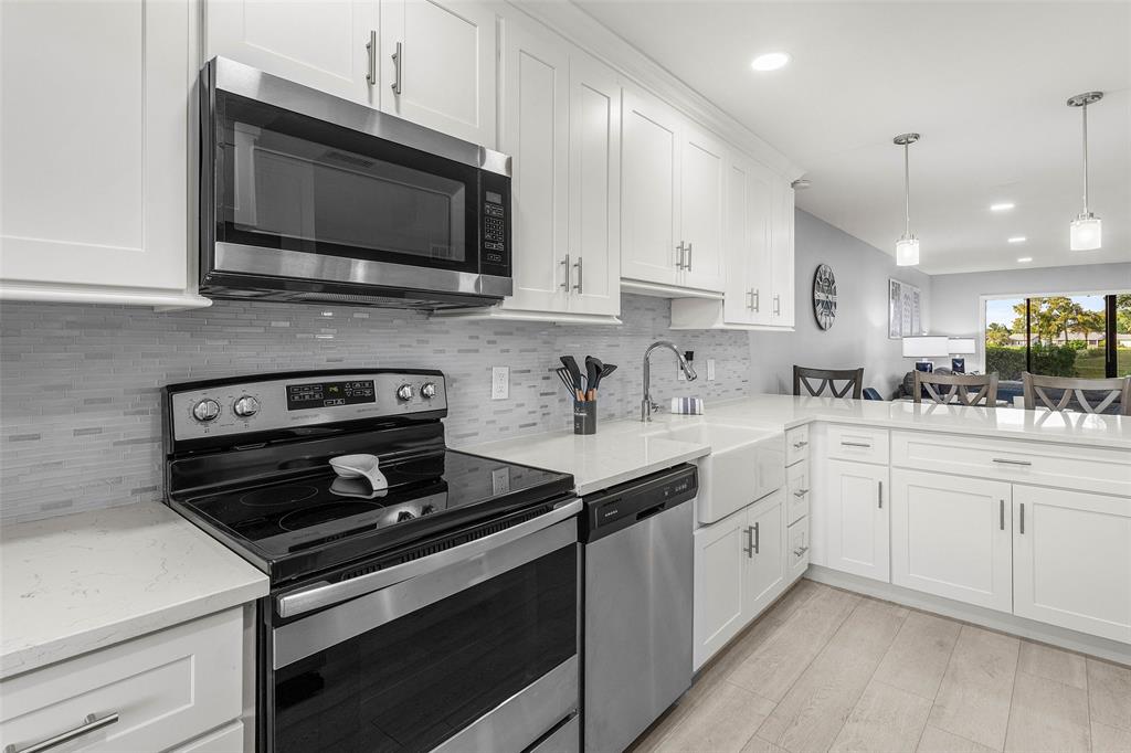 9286 Vista Del Lago, Unit E Boca Raton, FL 33428 - Photo 6 of 26 a kitchen with a sink stove and microwave