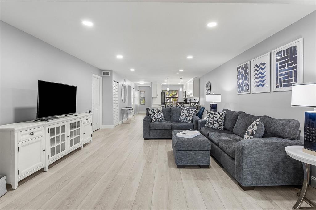 9286 Vista Del Lago, Unit E Boca Raton, FL 33428 - Photo 9 of 26 a living room with furniture and a flat screen tv