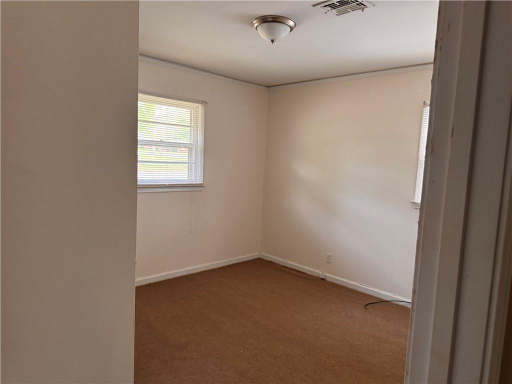 814 Avondale Road Montgomery, AL 36109 - Photo 7 of 10 Spare room featuring dark carpet and baseboards