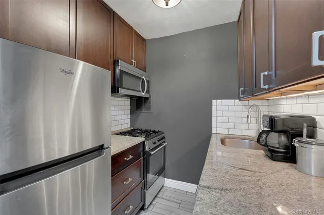 a kitchen with stainless steel appliances a refrigerator and a stove