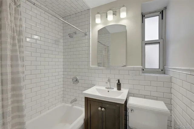 a bathroom with a sink a toilet and bathtub