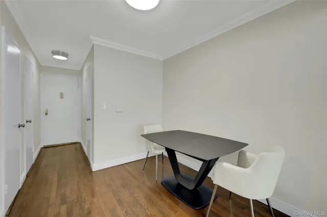 a view of a kitchen with furniture and wooden floor